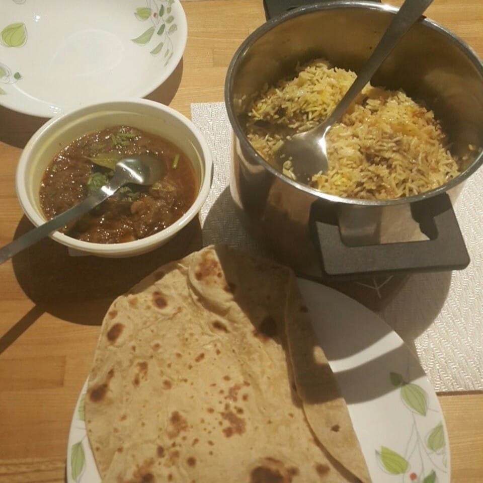 Biryani, curry and freshly made chapati, packed to take away at Marhaba