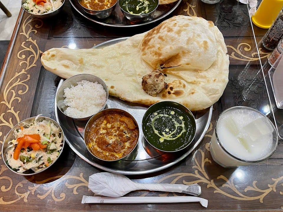 A thali with fresh naan, two curries and a lassi at KHANA Indian Restaurant