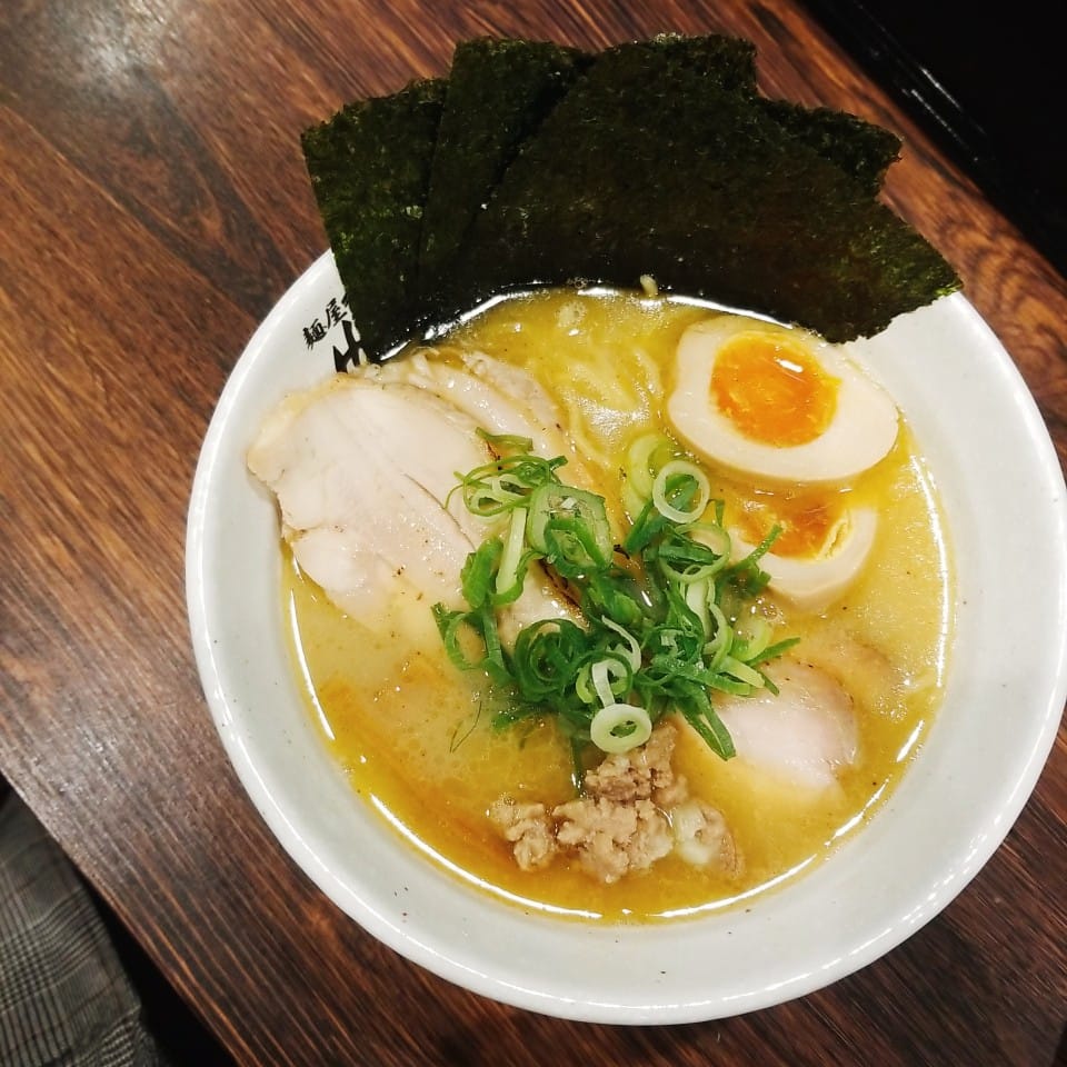 A bowl with chicken chashu, a marinated egg and nori at Halal Ramen Honolu Osaka Namba