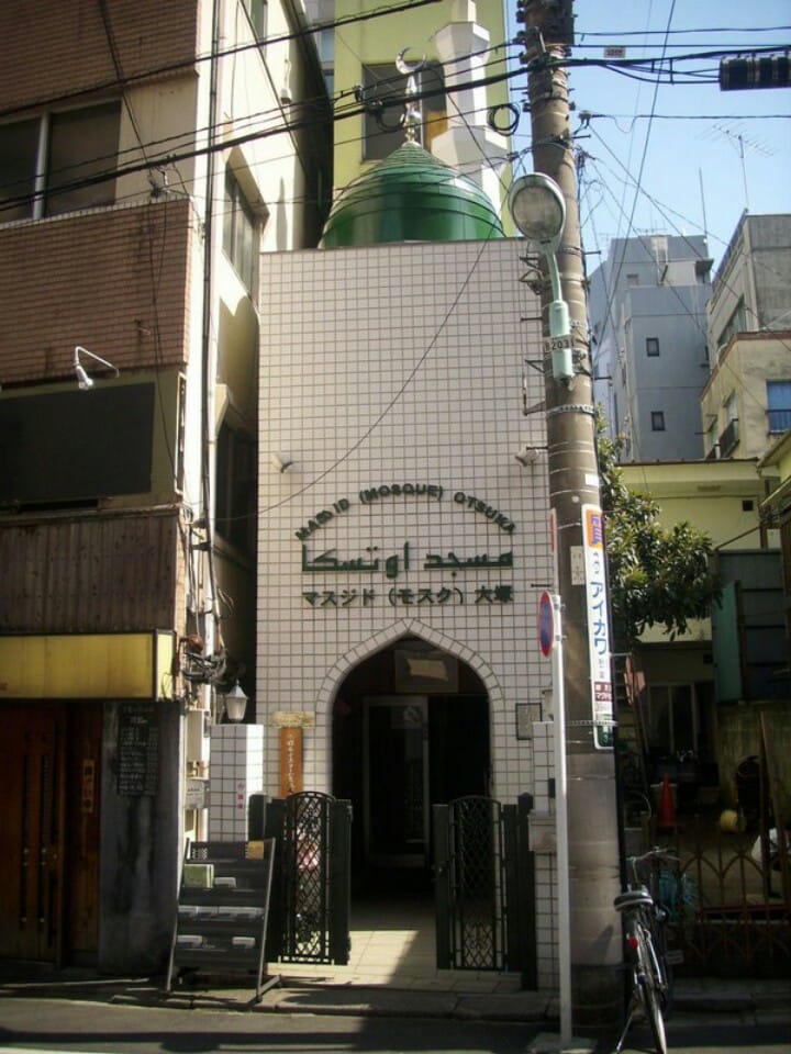 The white-tiled facade and green dome of Masjid Otsuka
