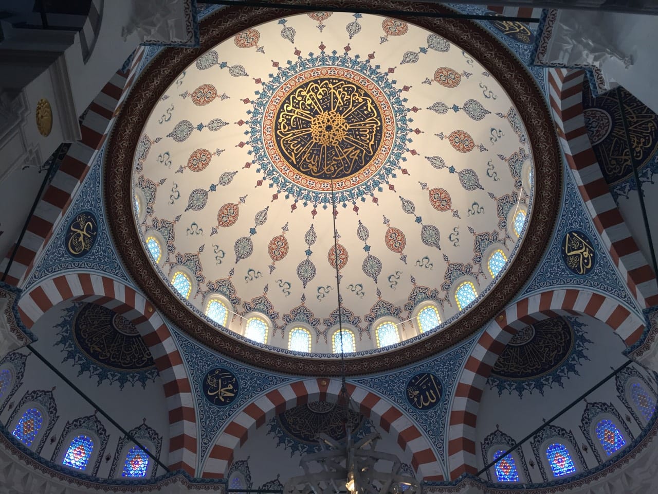 The painted dome and stained glass of the main prayer hall at Tokyo Camii