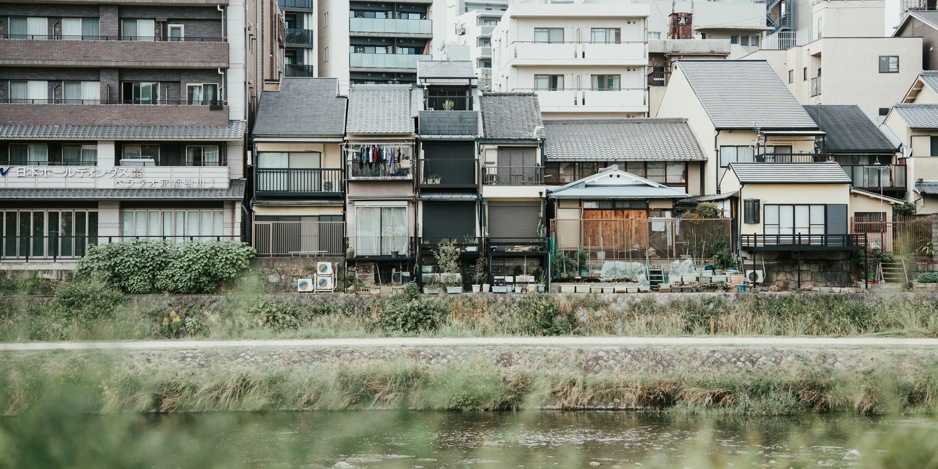 Traditional wooden townhouses along a river in Kyoto