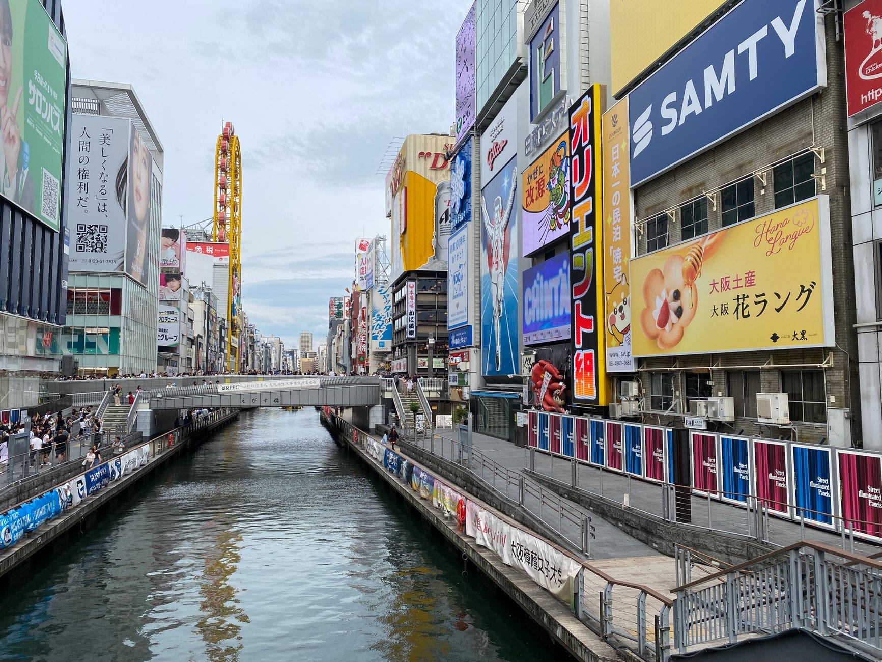 Dotonbori canal in Osaka lined with large illuminated signs