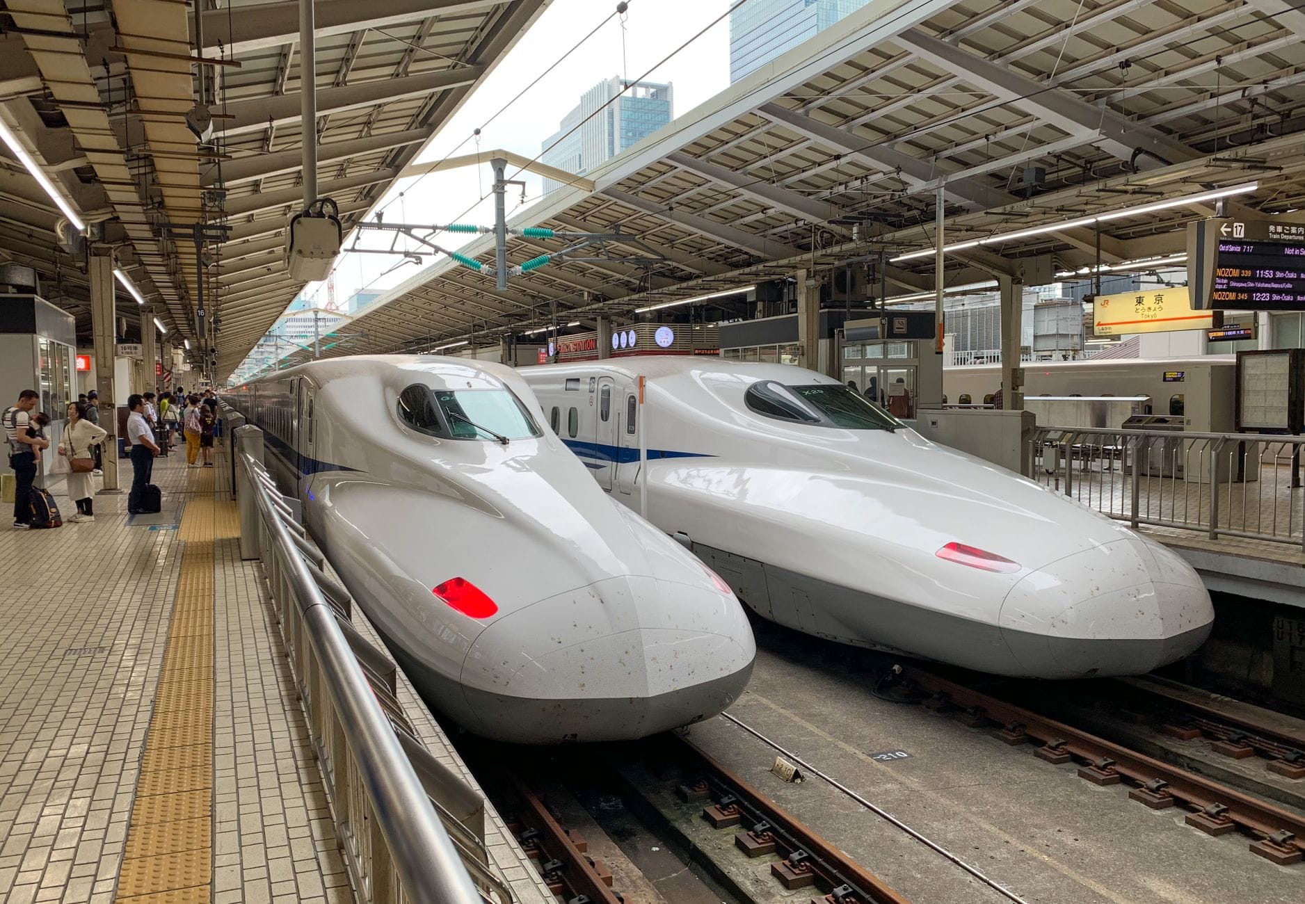 Two Shinkansen bullet trains at a station platform